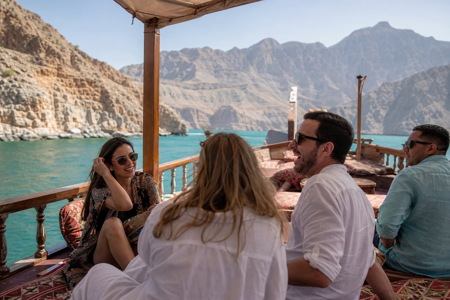 Group of friends enjoying dhow cruise in Khasab Musandam fjords